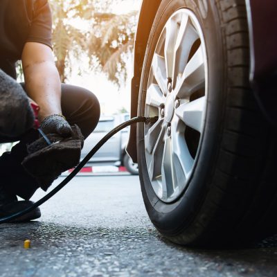 Technician is inflate car tire - car maintenance service transportation safety concept